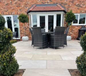 Comparison of natural stone and porcelain patio materials in outdoor garden setting